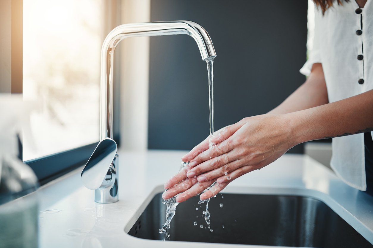 Women washing hands water heater services