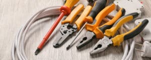 Different electrician's supplies on wooden floor