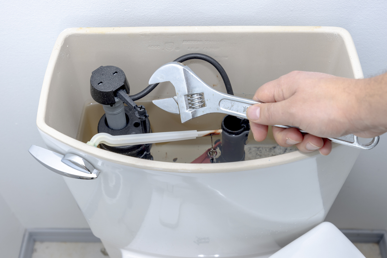Repairing Toilet with Wrench